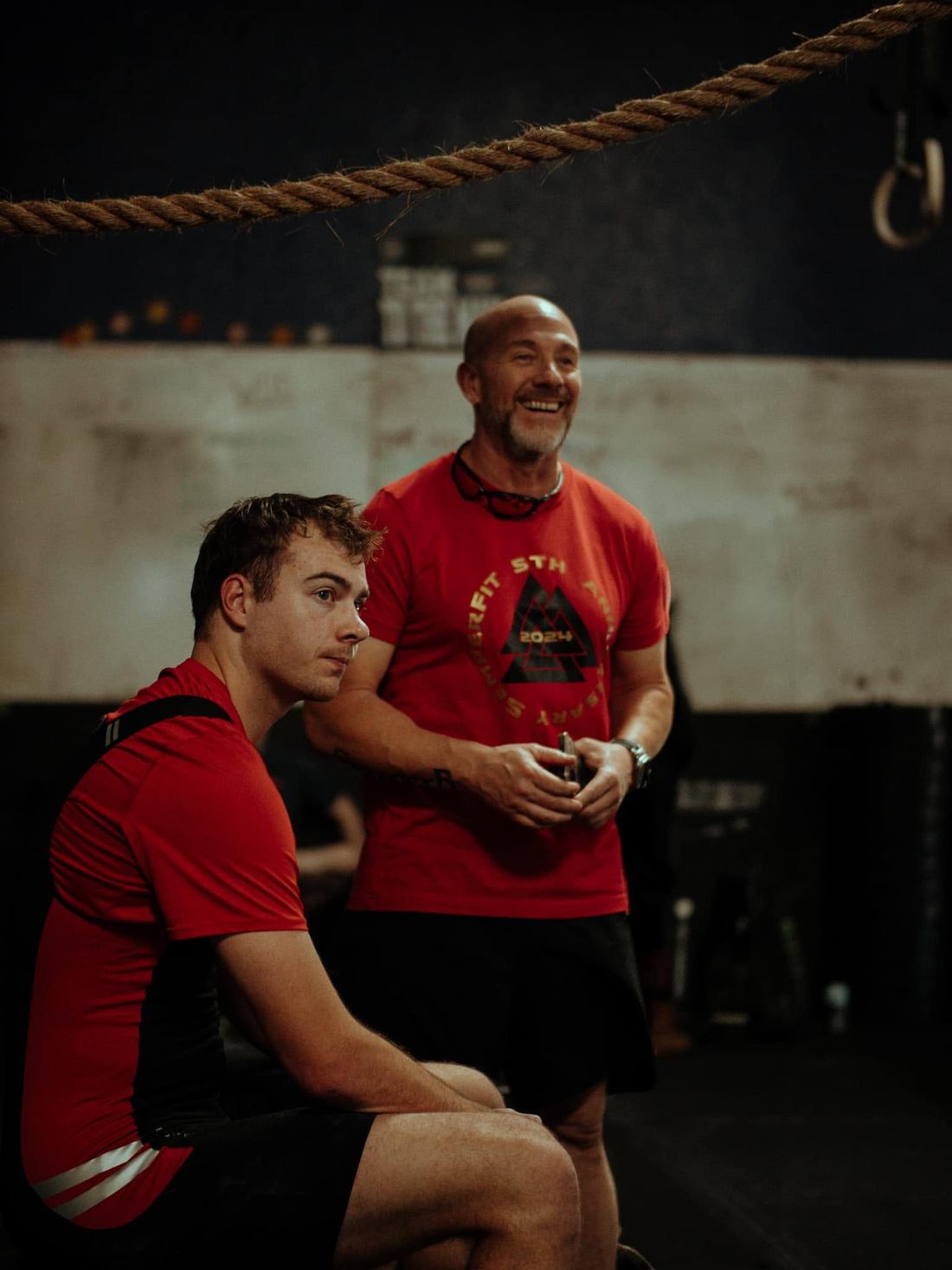 A SemperFit coach and athlete on the gym floor