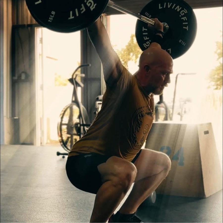 An athlete catching a snatch in the bottom of an overhead squat
